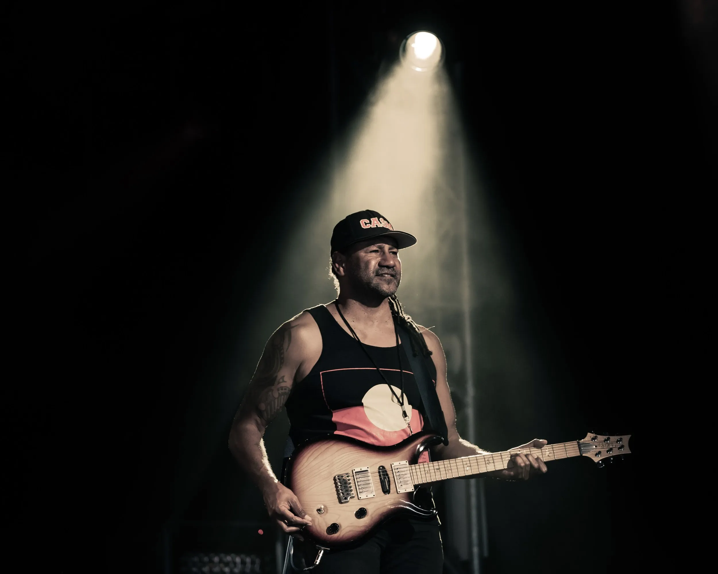 Guitarist in a single spotlight at Bluesfest Byron Bay, 2022, photographed by Kris Cook