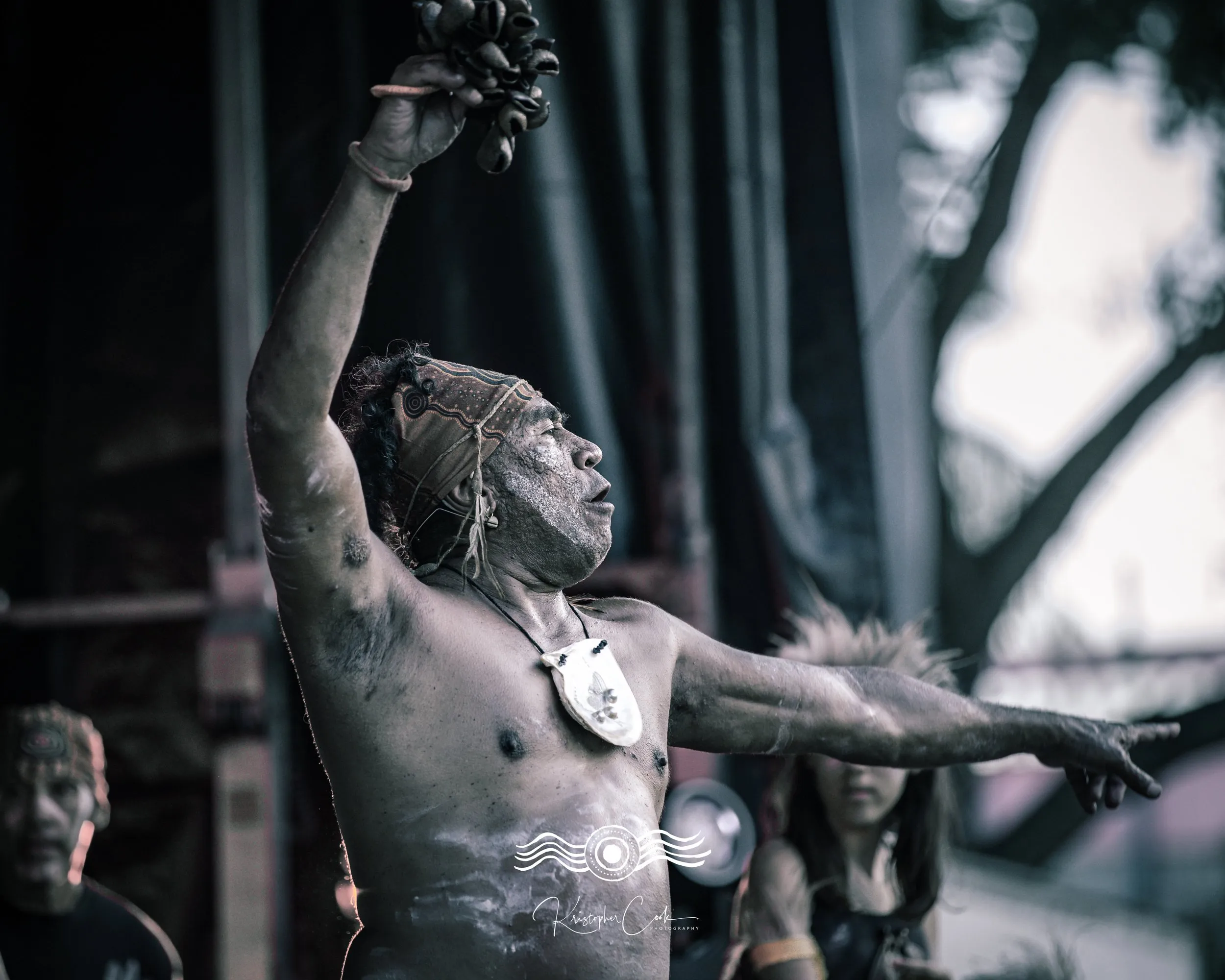 Dancer in ochre with arms raised on stage at Groove on the Grass, Grafton, 2023, photographed by Kris Cook