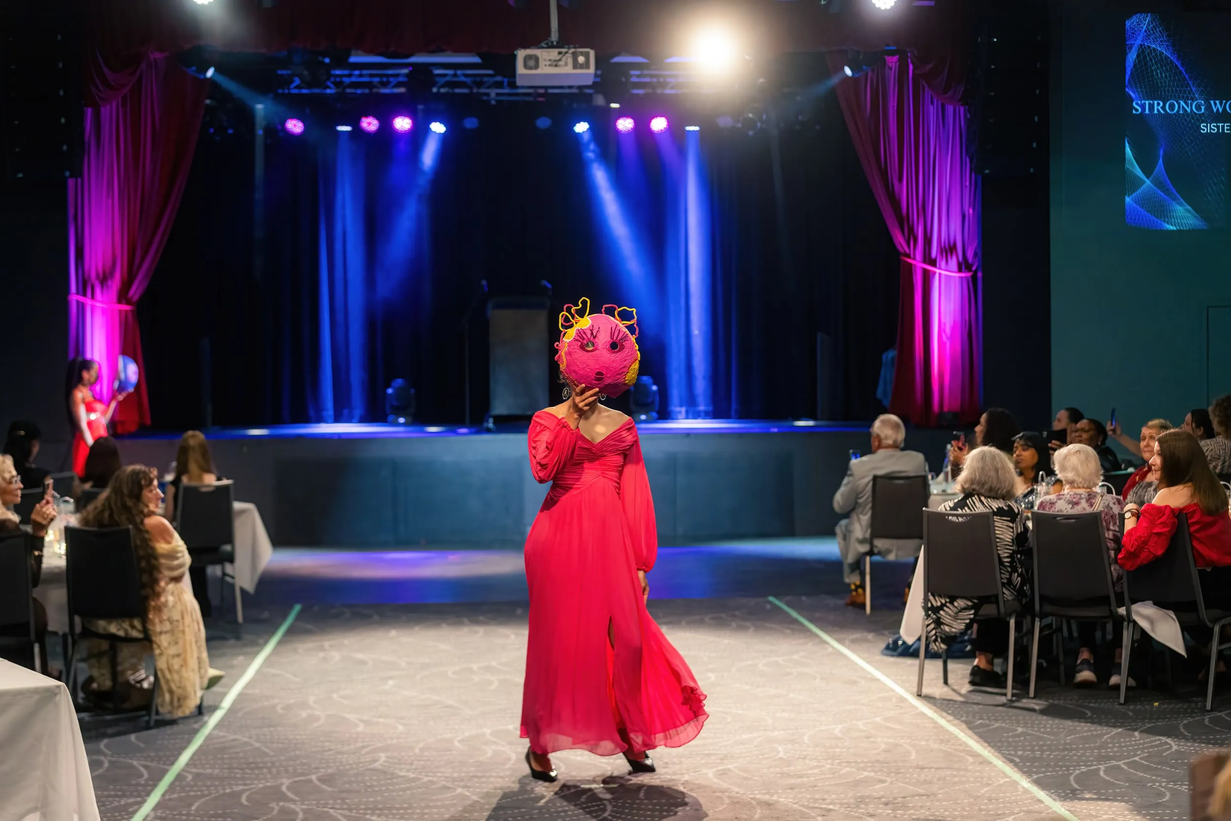 Red dress on the floor at Fashique Runway, Brisbane, 2026, photographed by Kris Cook