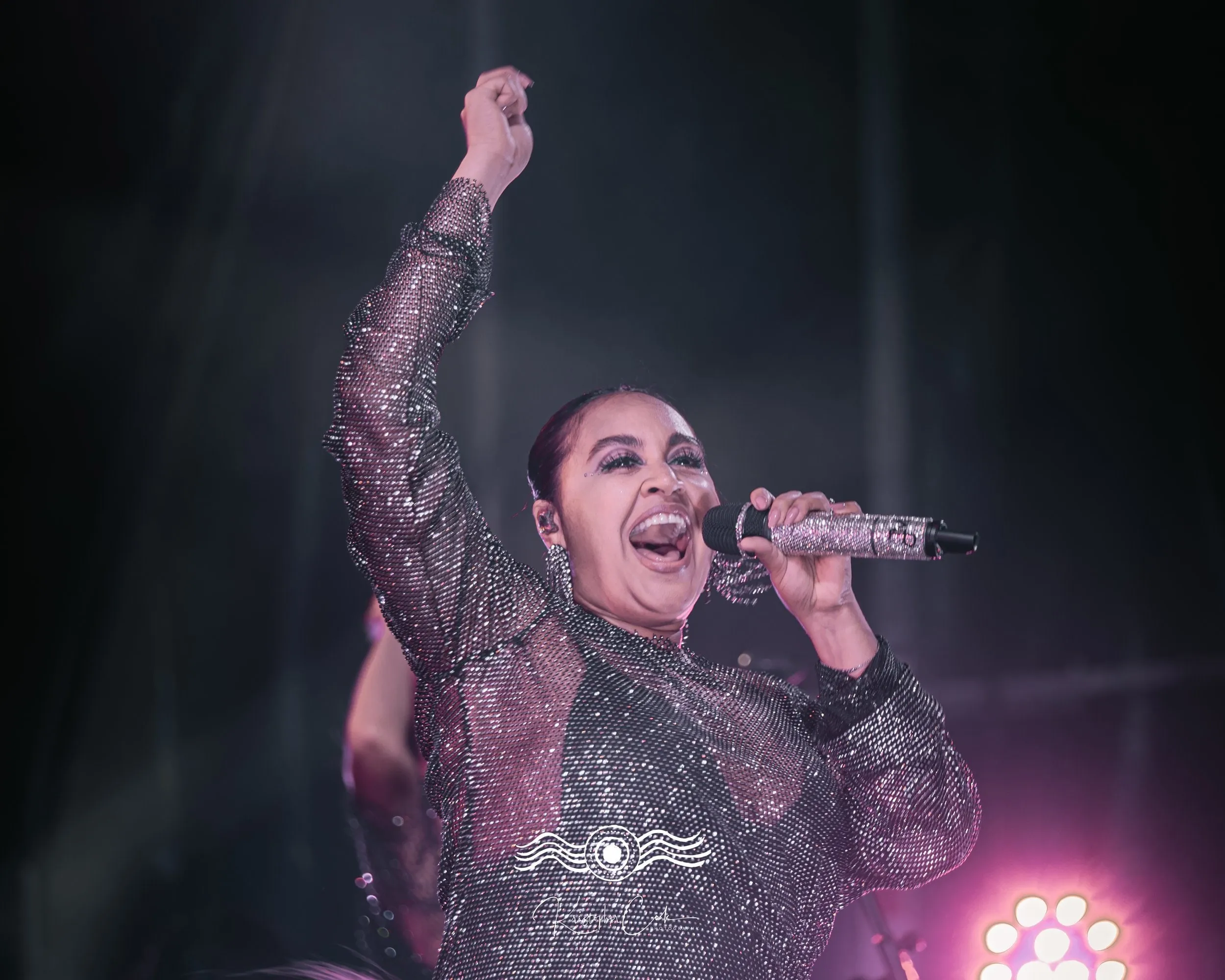 Fist in the air on stage at Groove on the Grass, Grafton, 2023, photographed by Kris Cook