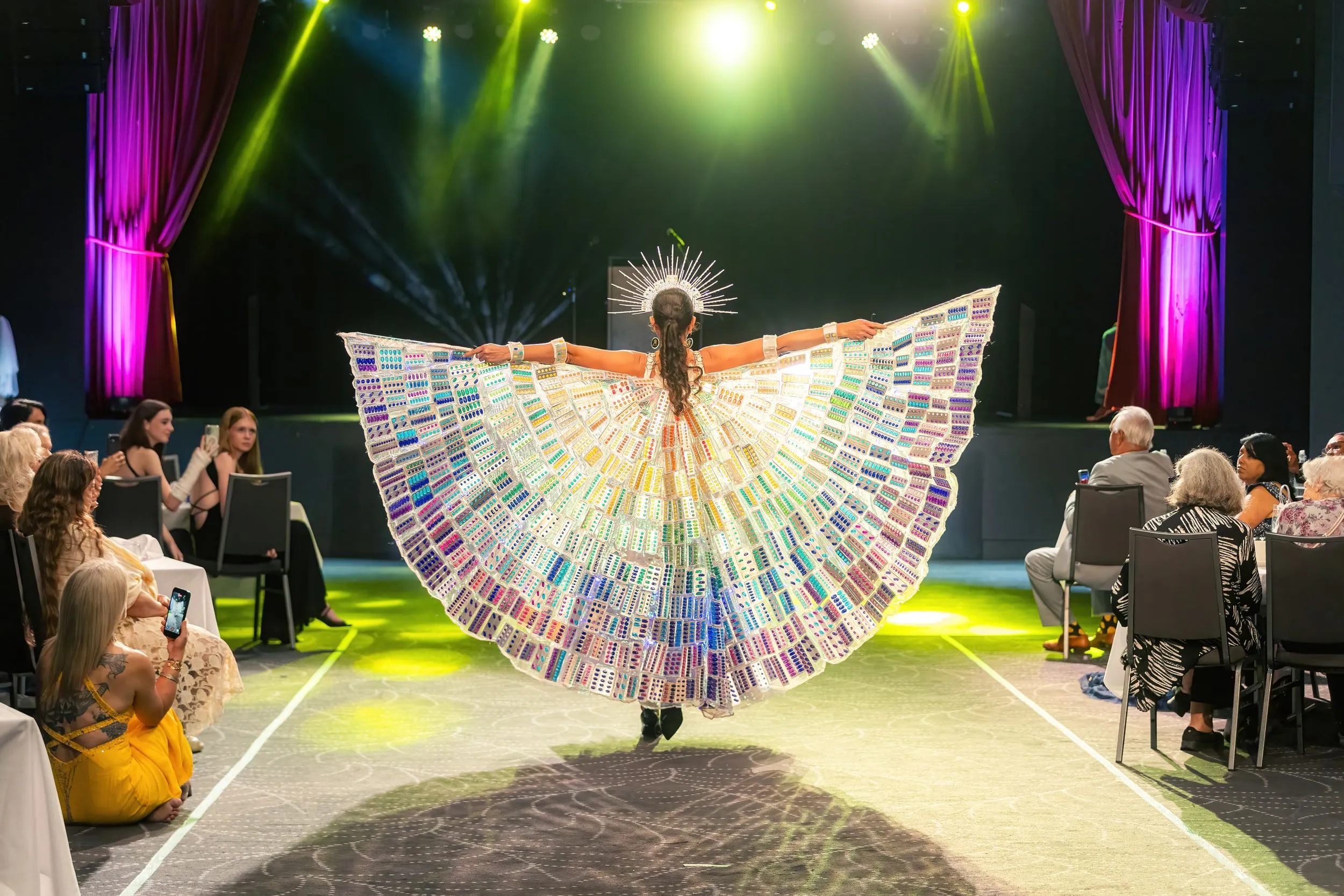 Rainbow wings on the runway at Fashique Runway, Brisbane, 2026, photographed by Kris Cook