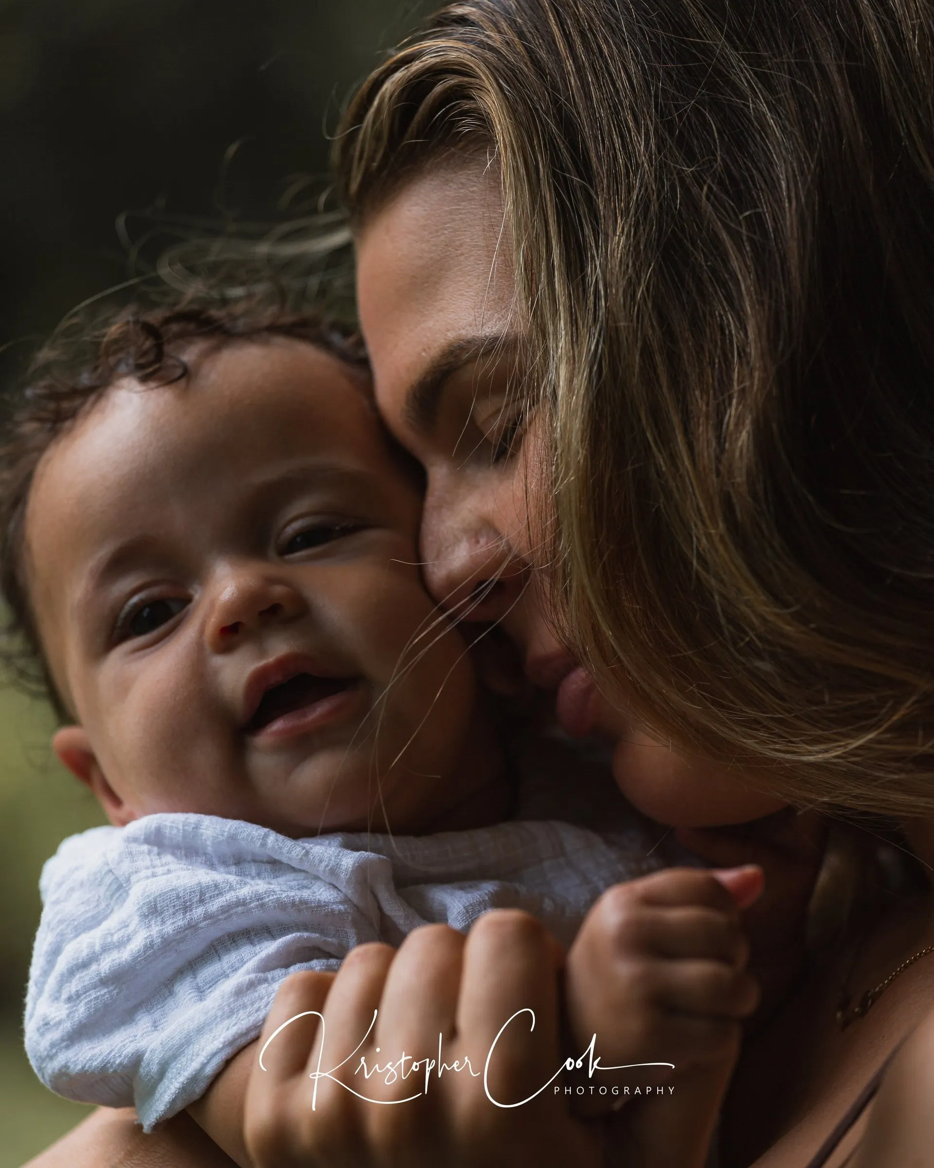 Mother and baby cheek to cheek, family portrait by Kris Cook