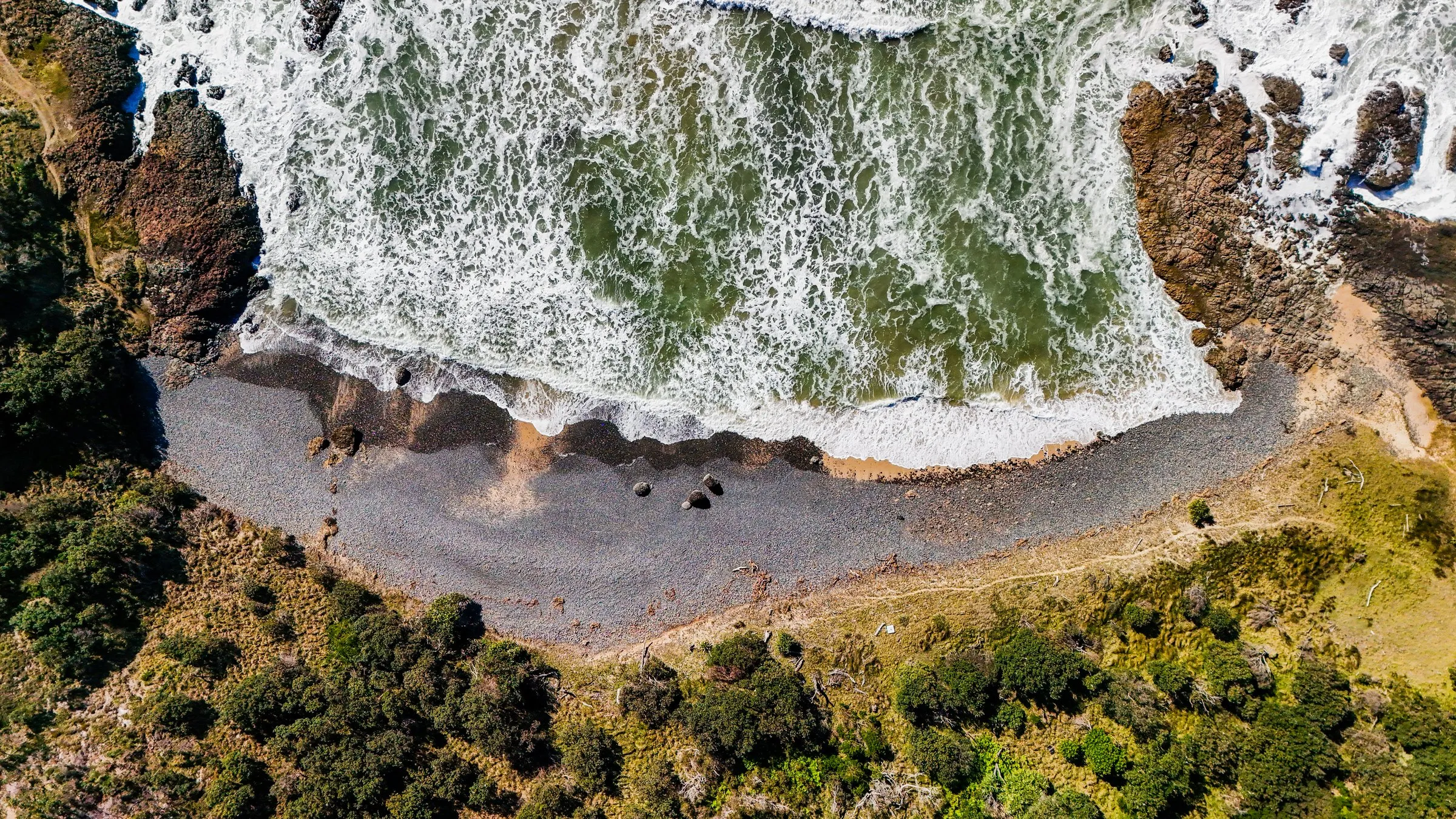 Drone view straight down over a cove and headland on the Northern Rivers coast, by Kris Cook