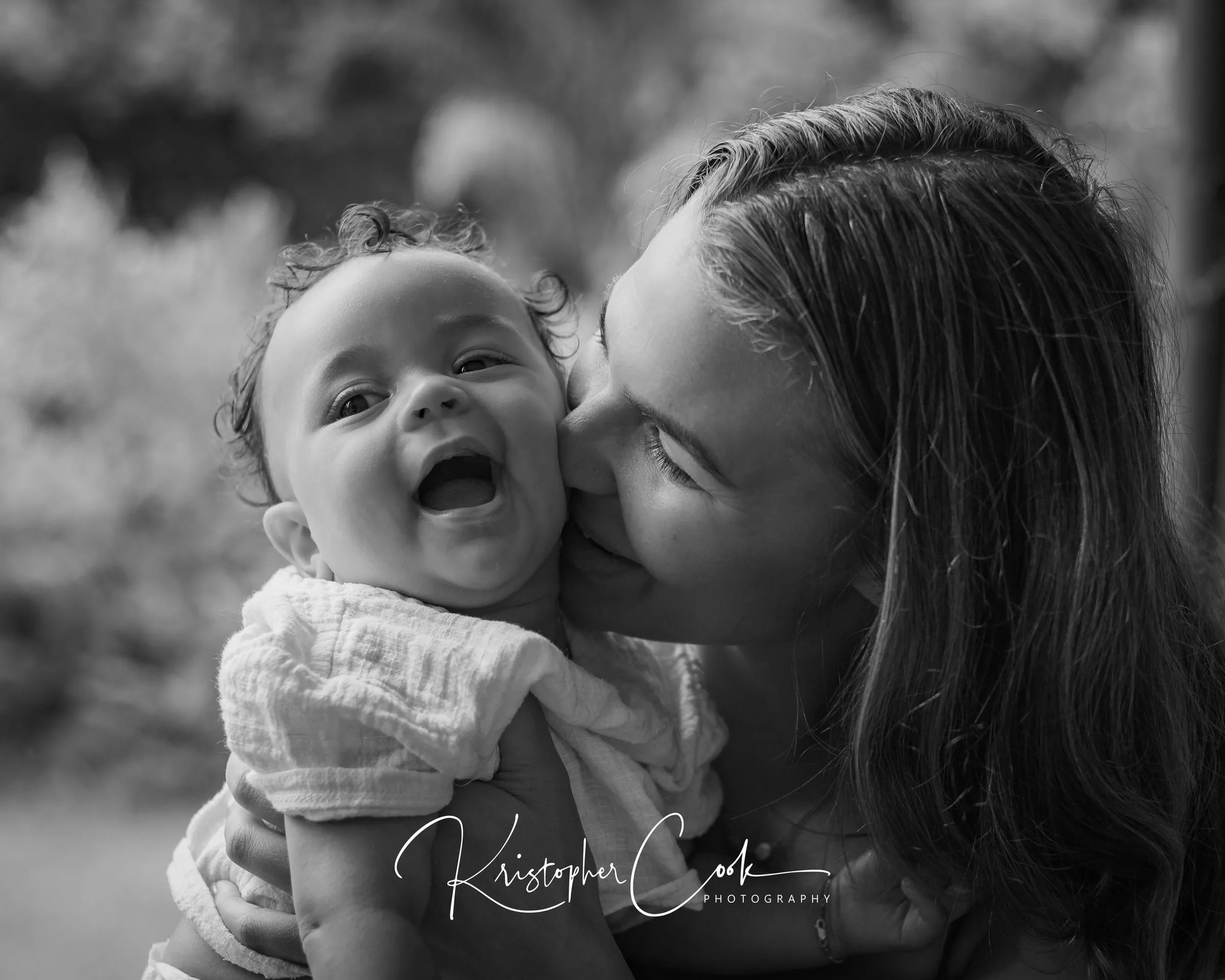 Mother and baby laughing together, photographed by Kris Cook